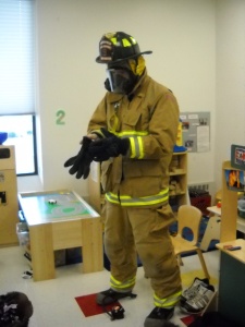Firefighter showing children his gear